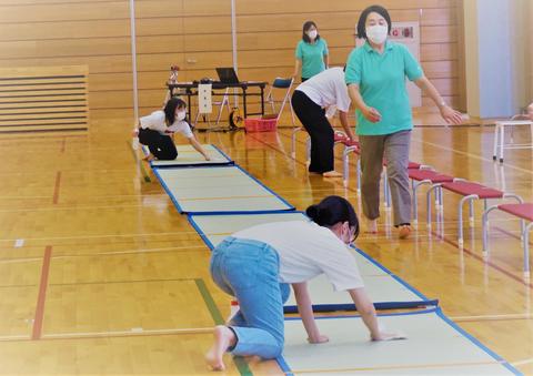 保護者席の消毒をする学生